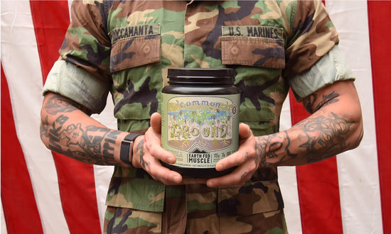 Active duty military member holding Earth Fed Muscle common ground plant protein