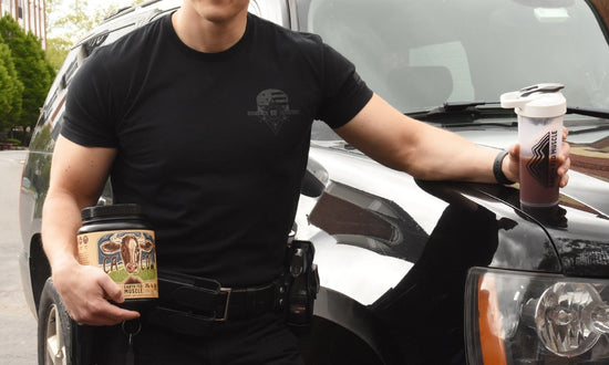 First Responder holding Earth Fed Muscle Chocolate Protein Powder