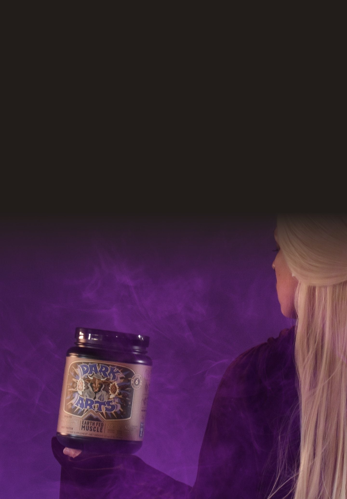 Woman holding Dark Arts salted chocolate grass-fed whey protein powder on purple background, portrait orientation